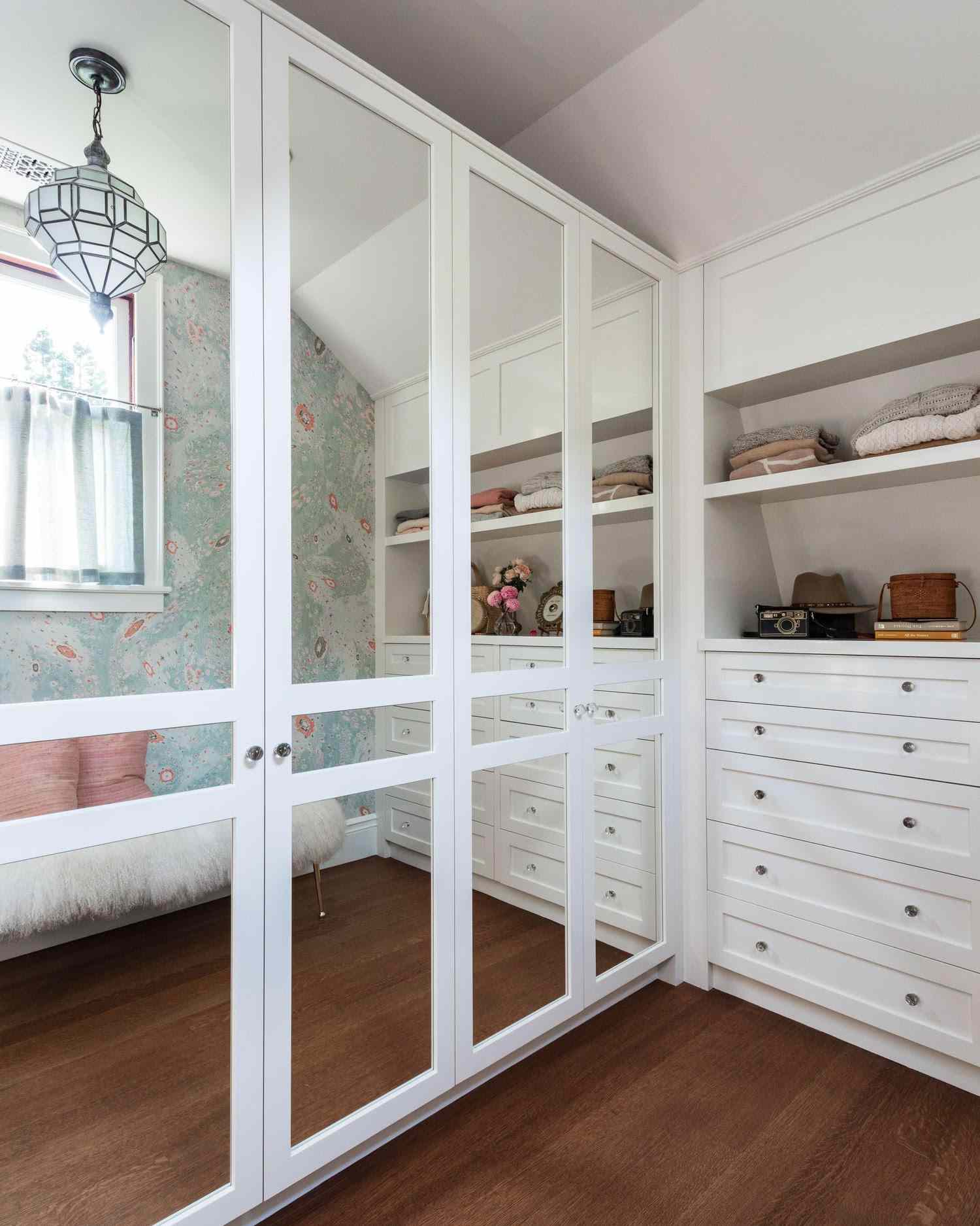 Schrank mit weißen Einbauschränken, Spiegelschränken und Dachschräge