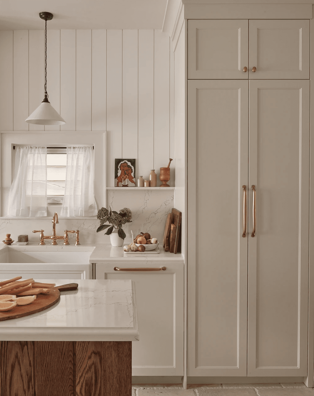 5 Designer genehmigte Möglichkeiten, Ihr Zuhause in ein minimalistisches Bauernhaus zu verwandeln 2 Eine weiß gefüllte Küche mit einem kleinen Fenster mit Jalousien und Vorhängen