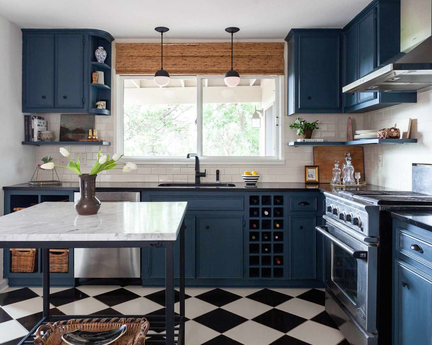 A kitchen with blue cabinetry