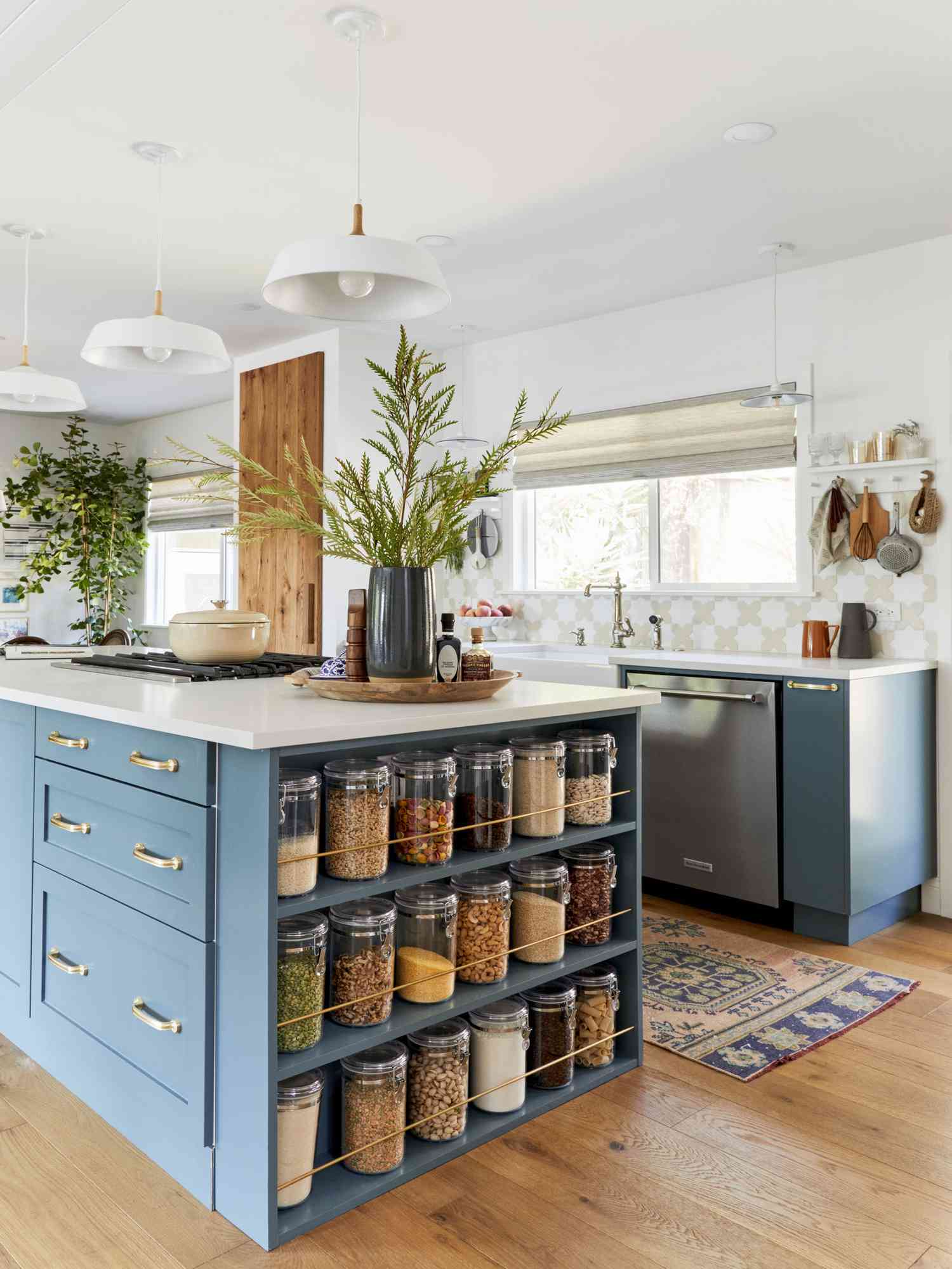 A blue kitchen island with shelving