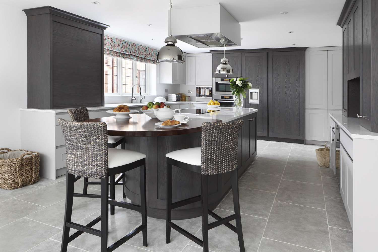 A kitchen island with a curved wood table attached