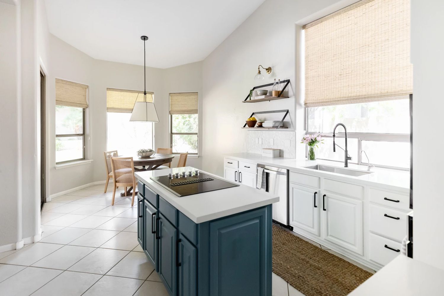 Blue kitchen island in a white kitchen