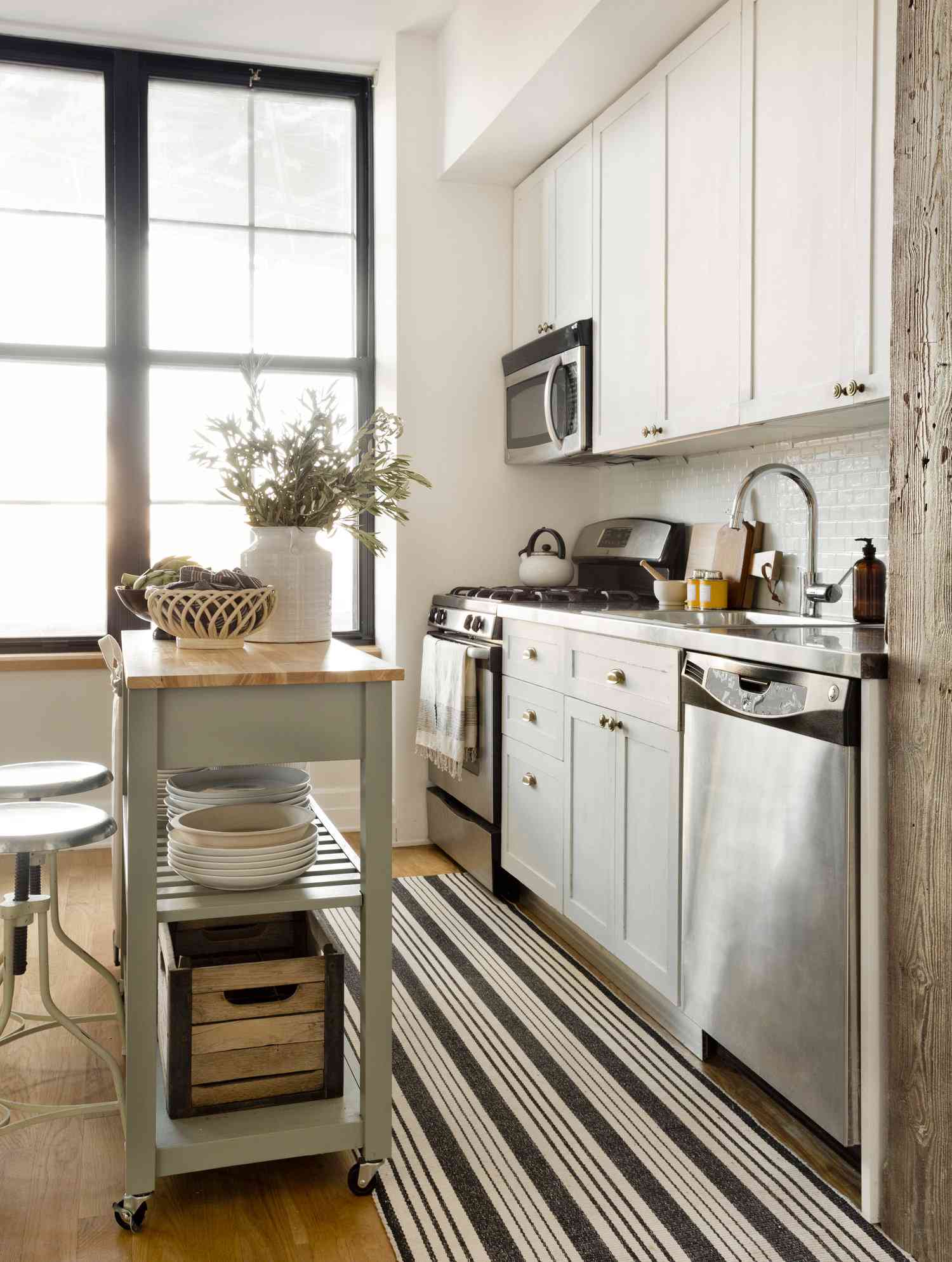 A small sage green kitchen island