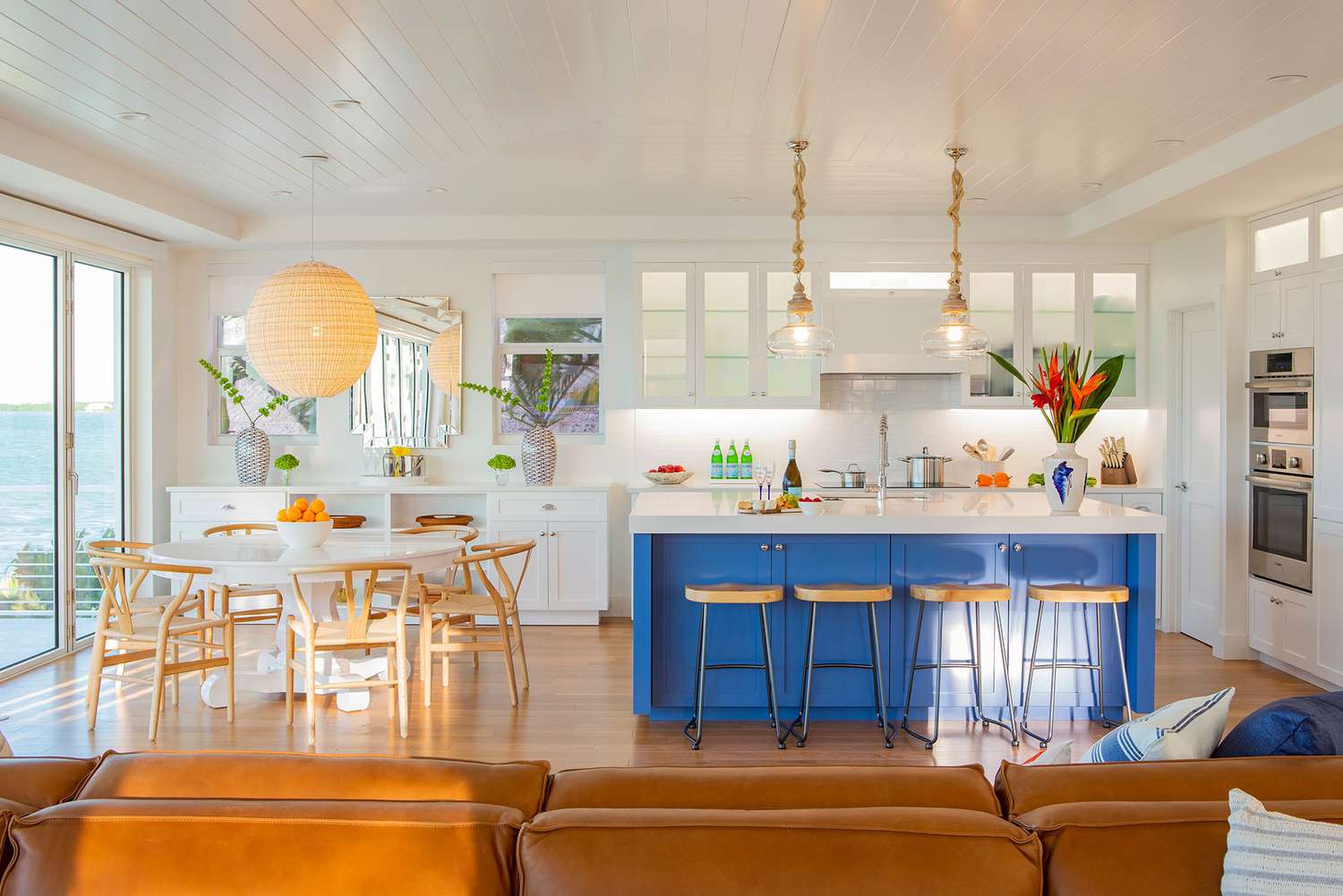 A bright blue kitchen island in a coastal kitchen