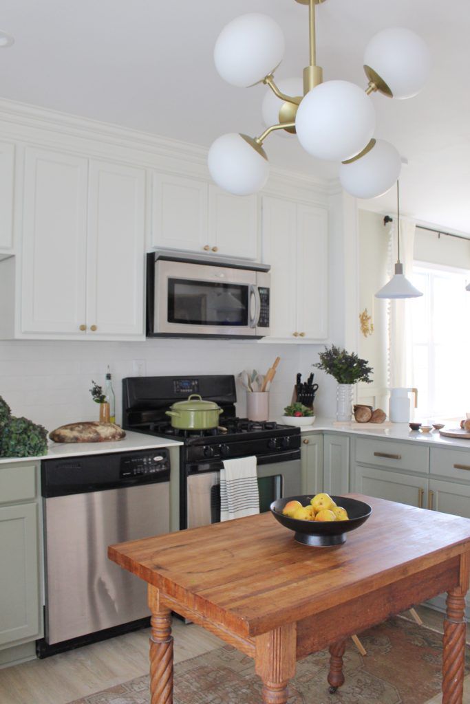 A kitchen with a wood table as an island