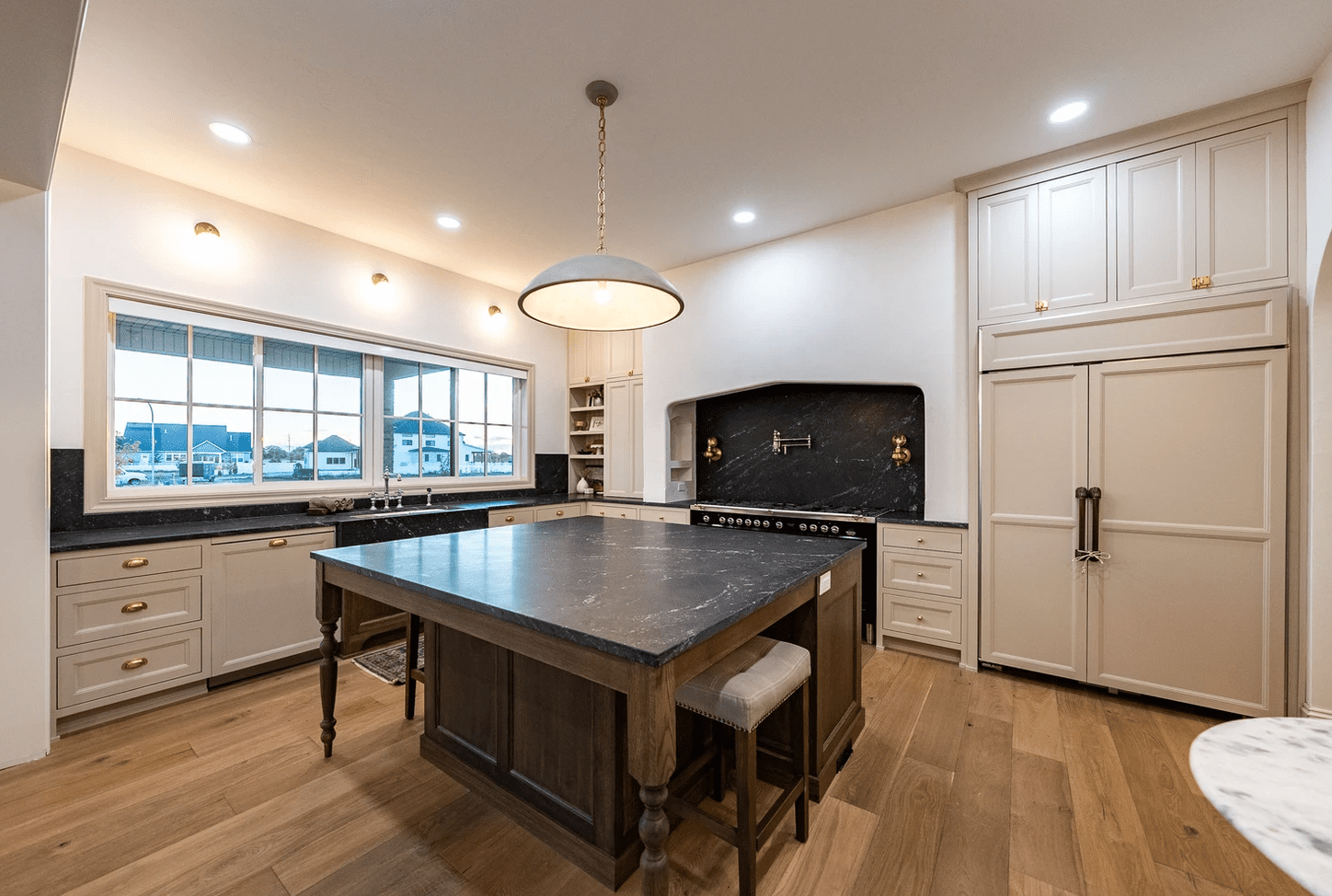 large kitchen island with black marble surface