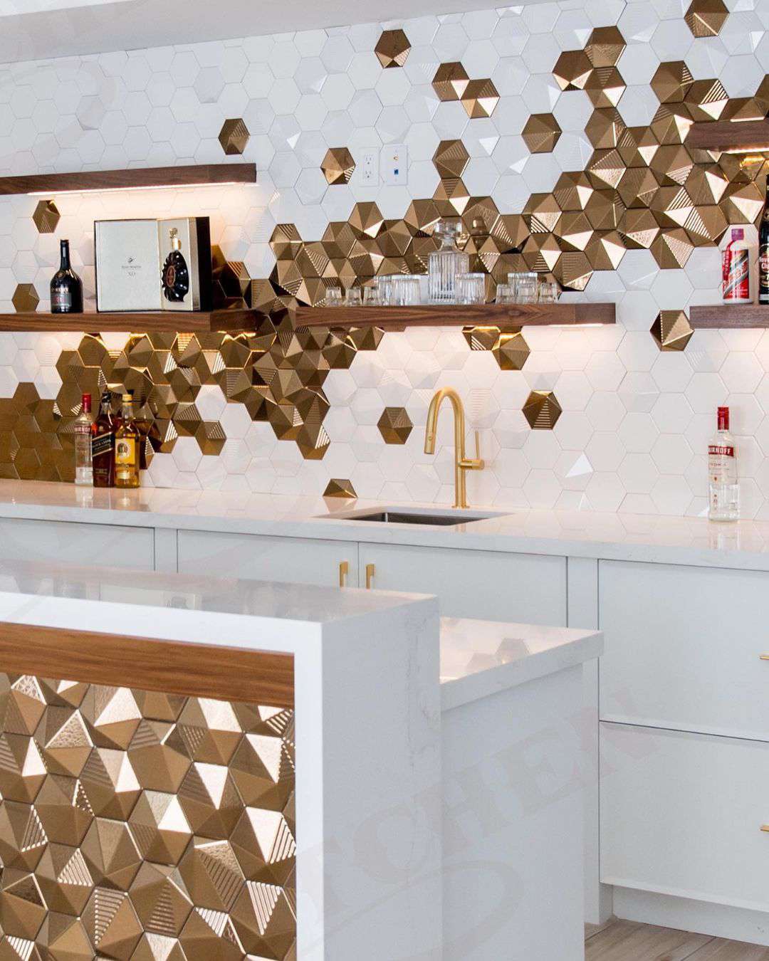 Gold hexagon tiles on a kitchen island and backsplash