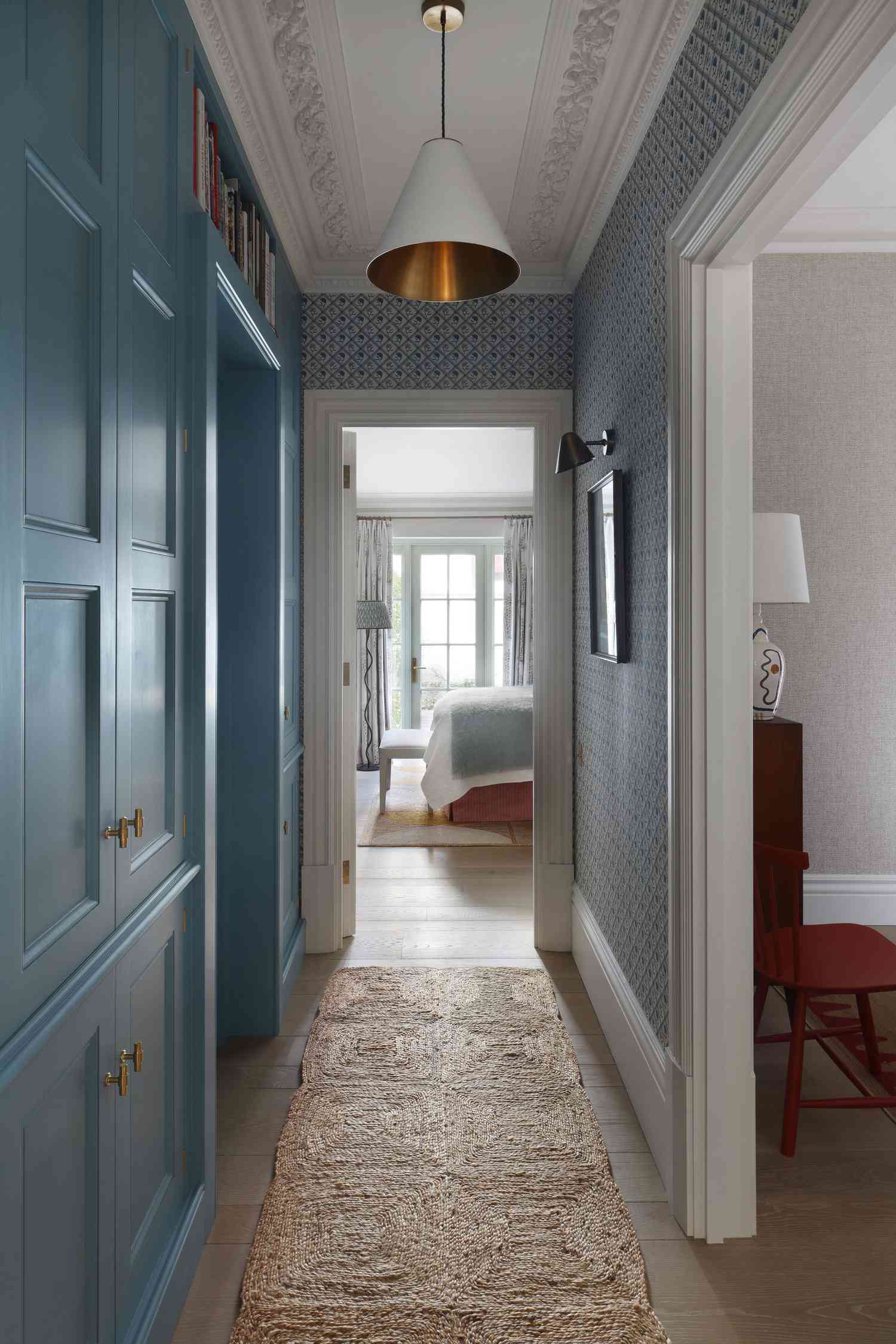 Narrow hallway with blue built-ins