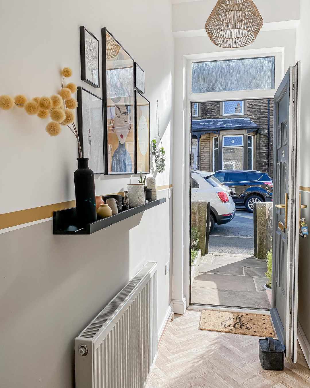 Narrow hallway with a floating shelf and artwork above it