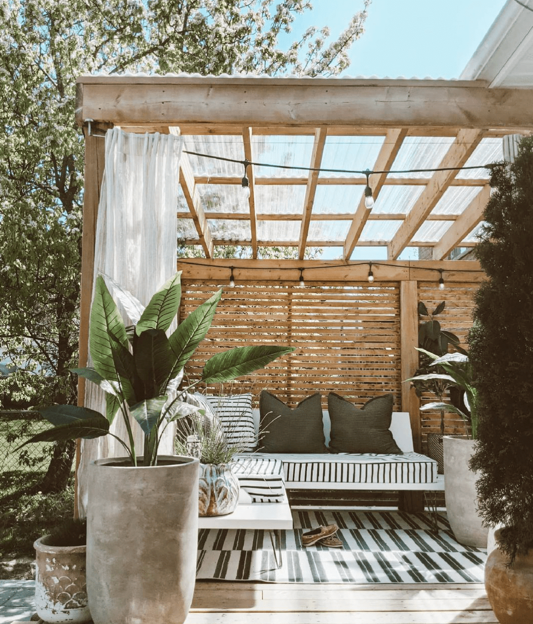 fake plants by pergola in backyard