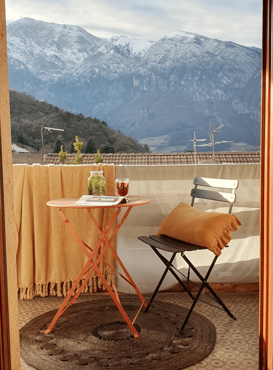 outdoor dining area with pillows and rug