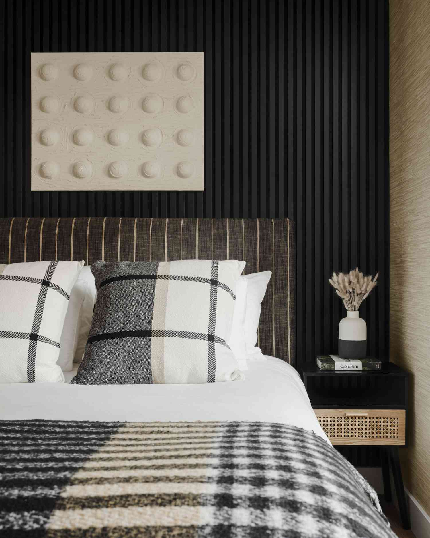 neutral artwork over the bed