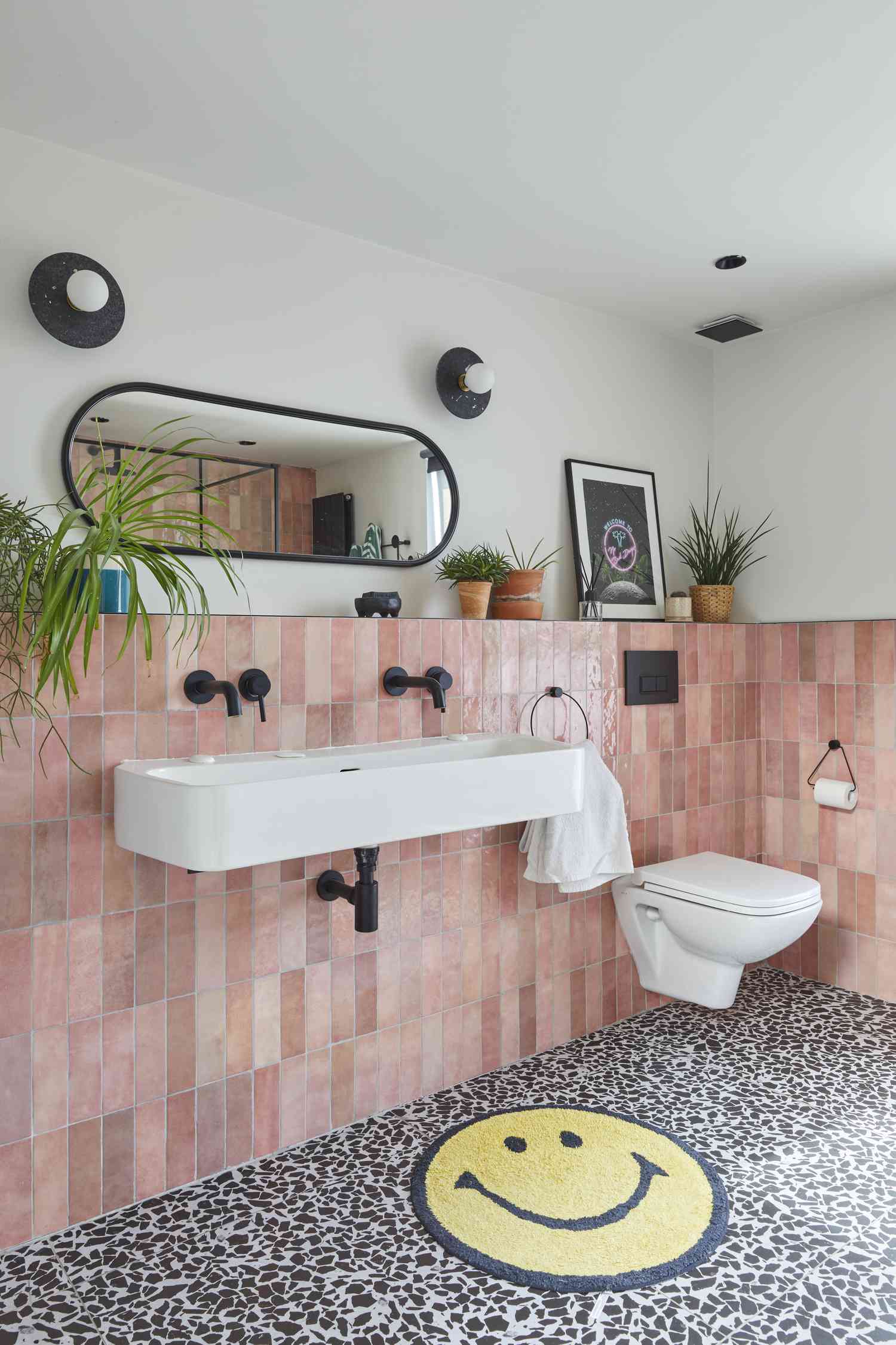 Pink tile and black and white floor in bathroom