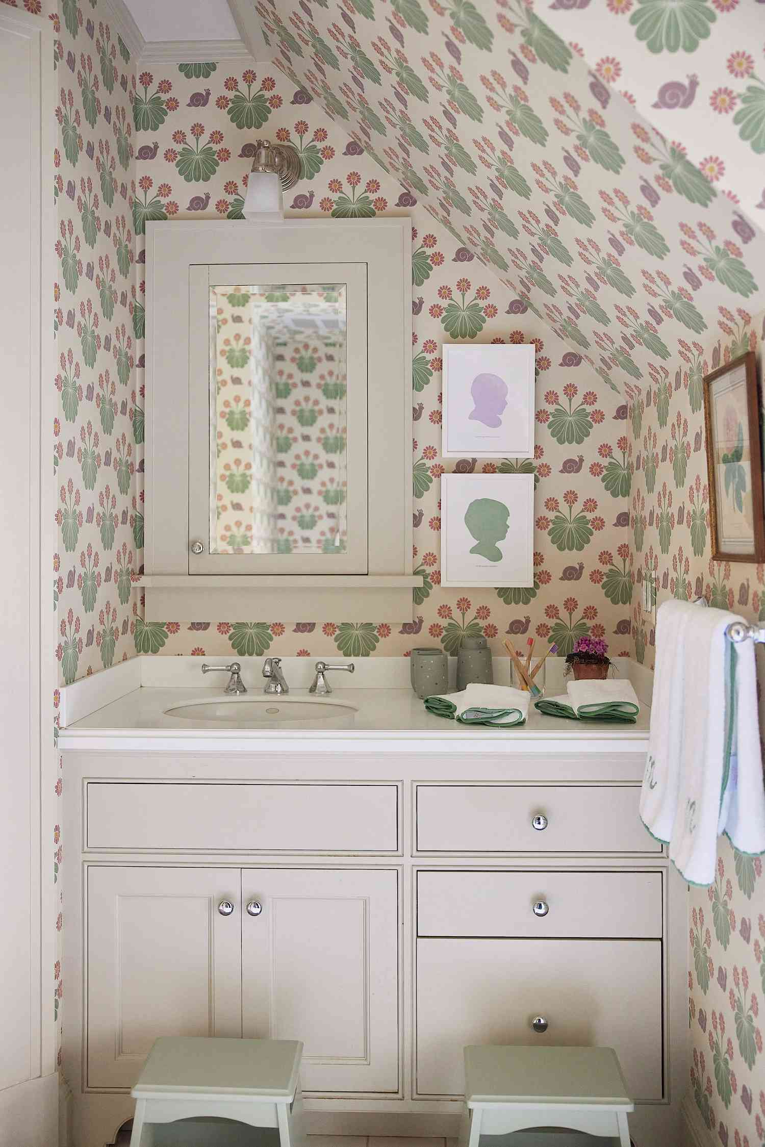 wallpapered bathroom with custom art