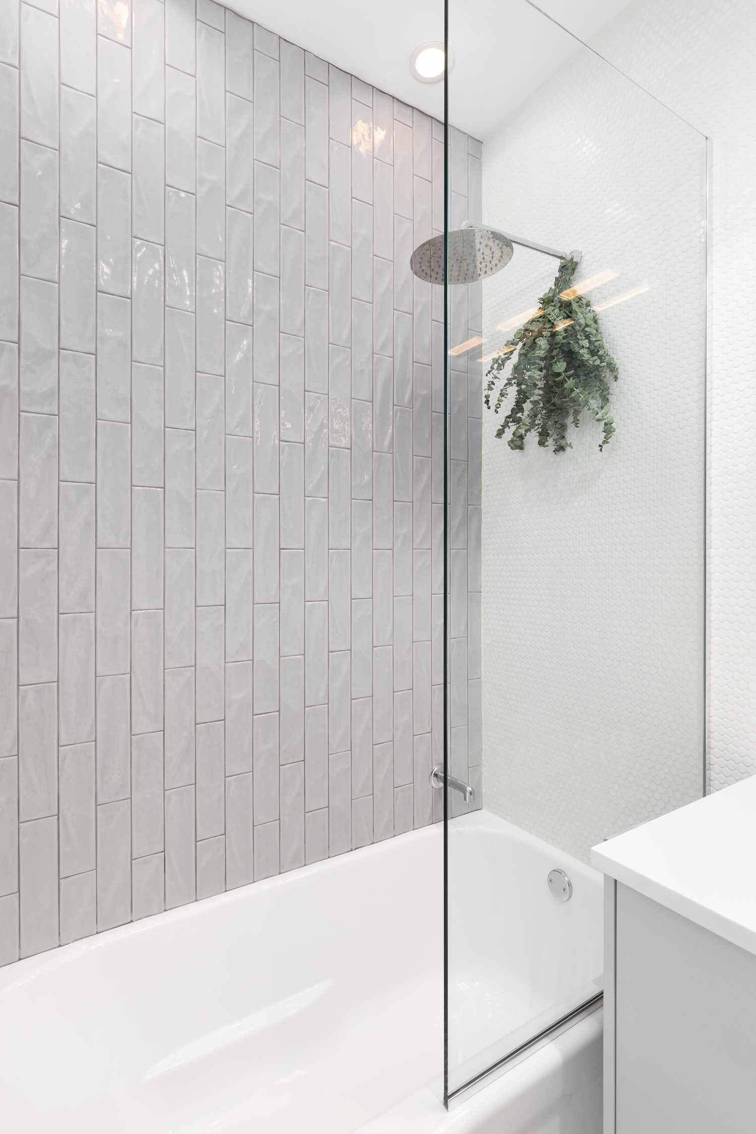 7 Designer-Approved Ways to Update Your Outdated Pre-Fab Shower Without a Full Reno 8 fresh eucalyptus hanging from shower head