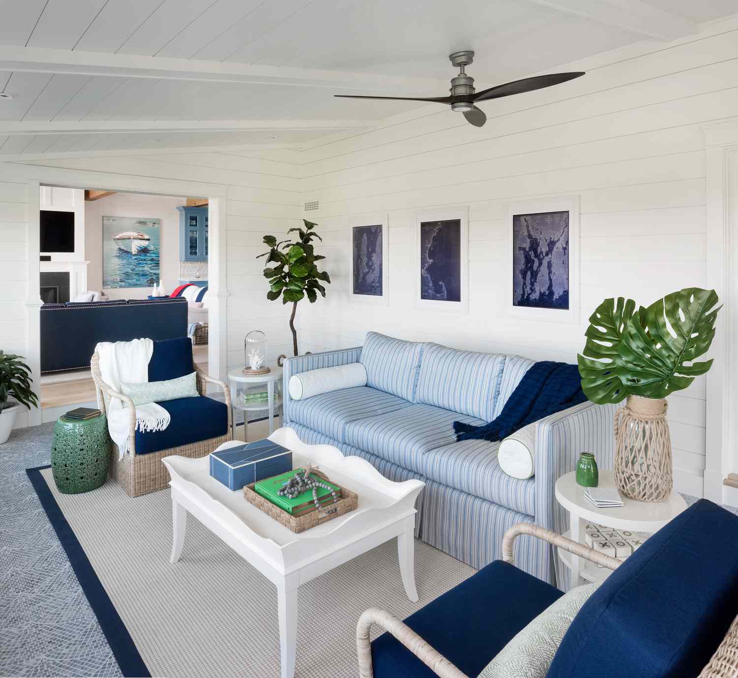 48 Small Sunroom Ideas for a Warm and Happy Space 14 Sunroom with blue and white furniture and fresh greenery