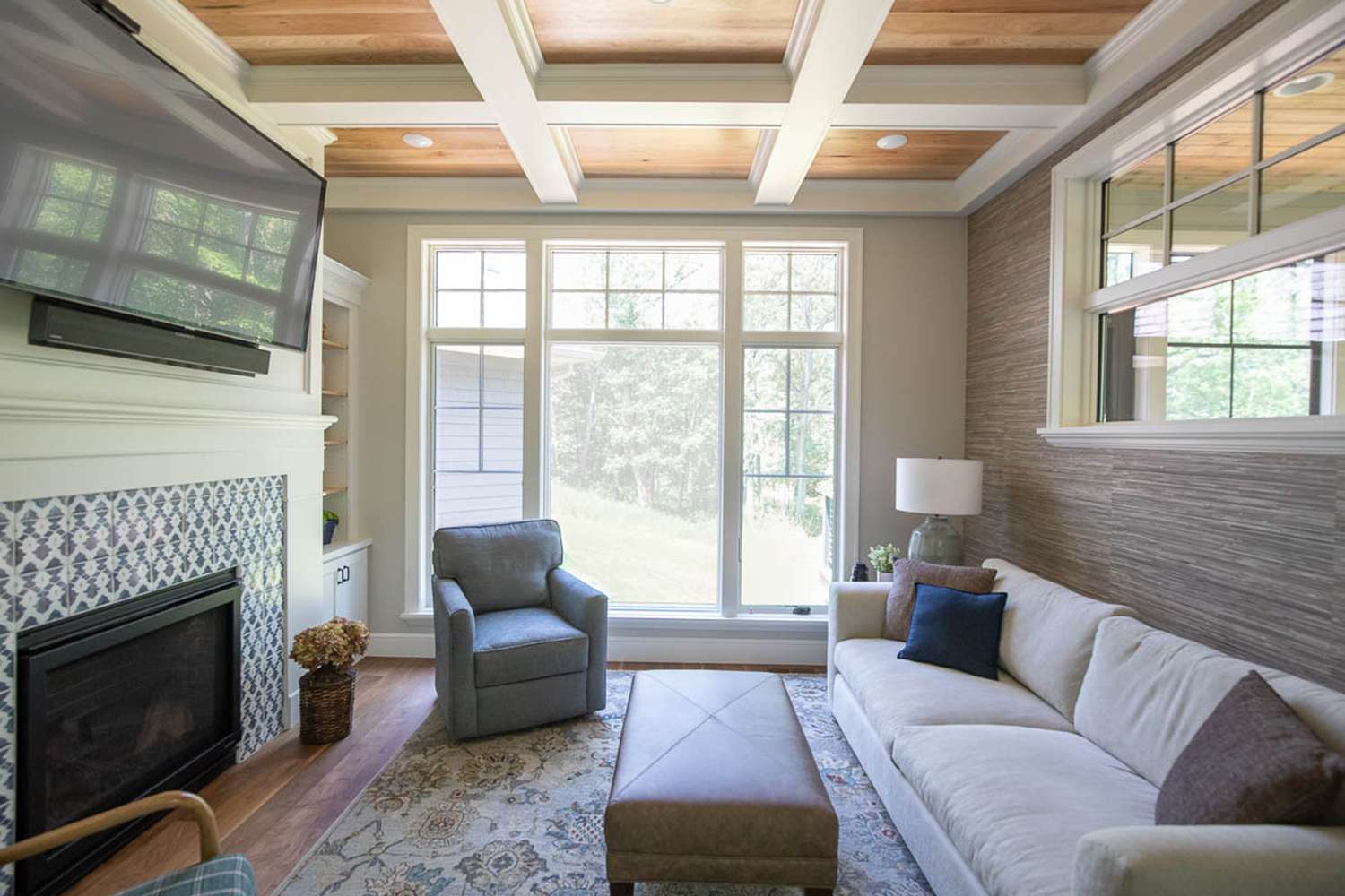 48 Small Sunroom Ideas for a Warm and Happy Space 34 Small sunroom with a coffered ceiling and a fireplace with a TV mounted above it