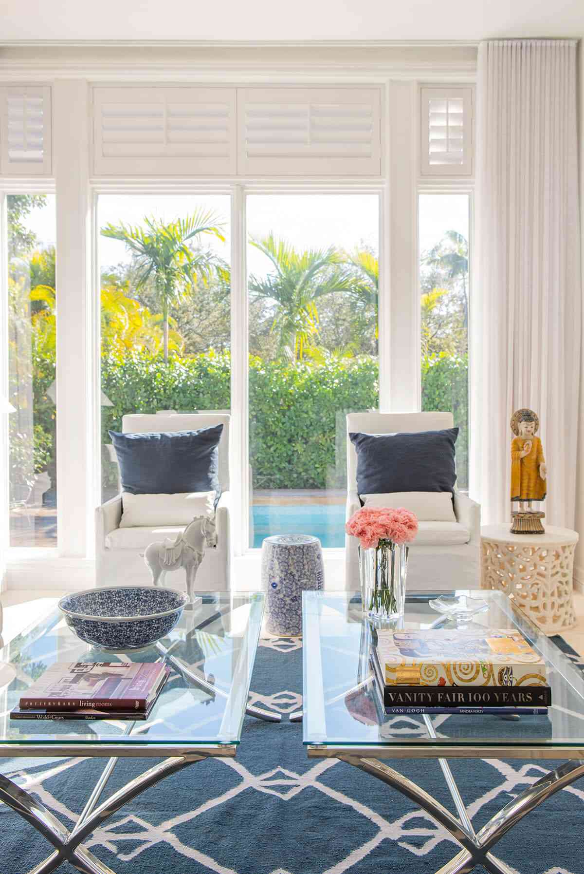 48 Small Sunroom Ideas for a Warm and Happy Space 44 Patterned area rug under two glass coffee tables in a modern sunroom