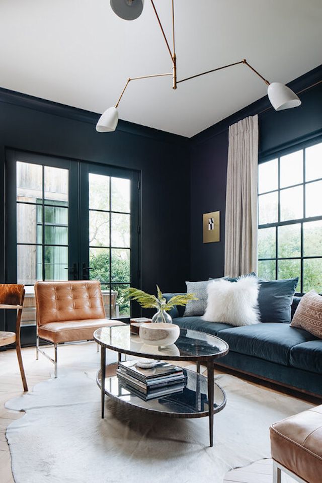 48 Small Sunroom Ideas for a Warm and Happy Space 32 Sunroom with dark wall color, a three-arm ceiling light, and modern furniture