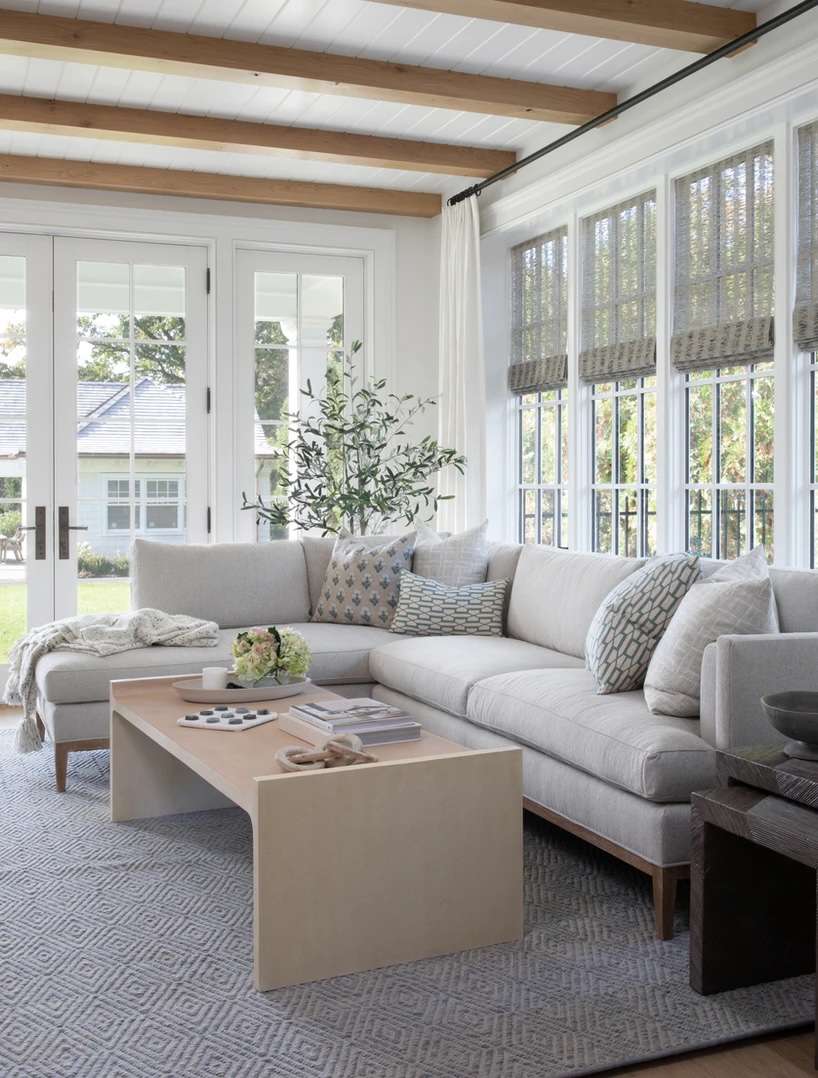 48 Small Sunroom Ideas for a Warm and Happy Space 18 White sunroom with wood ceiling beams and a light gray sectional