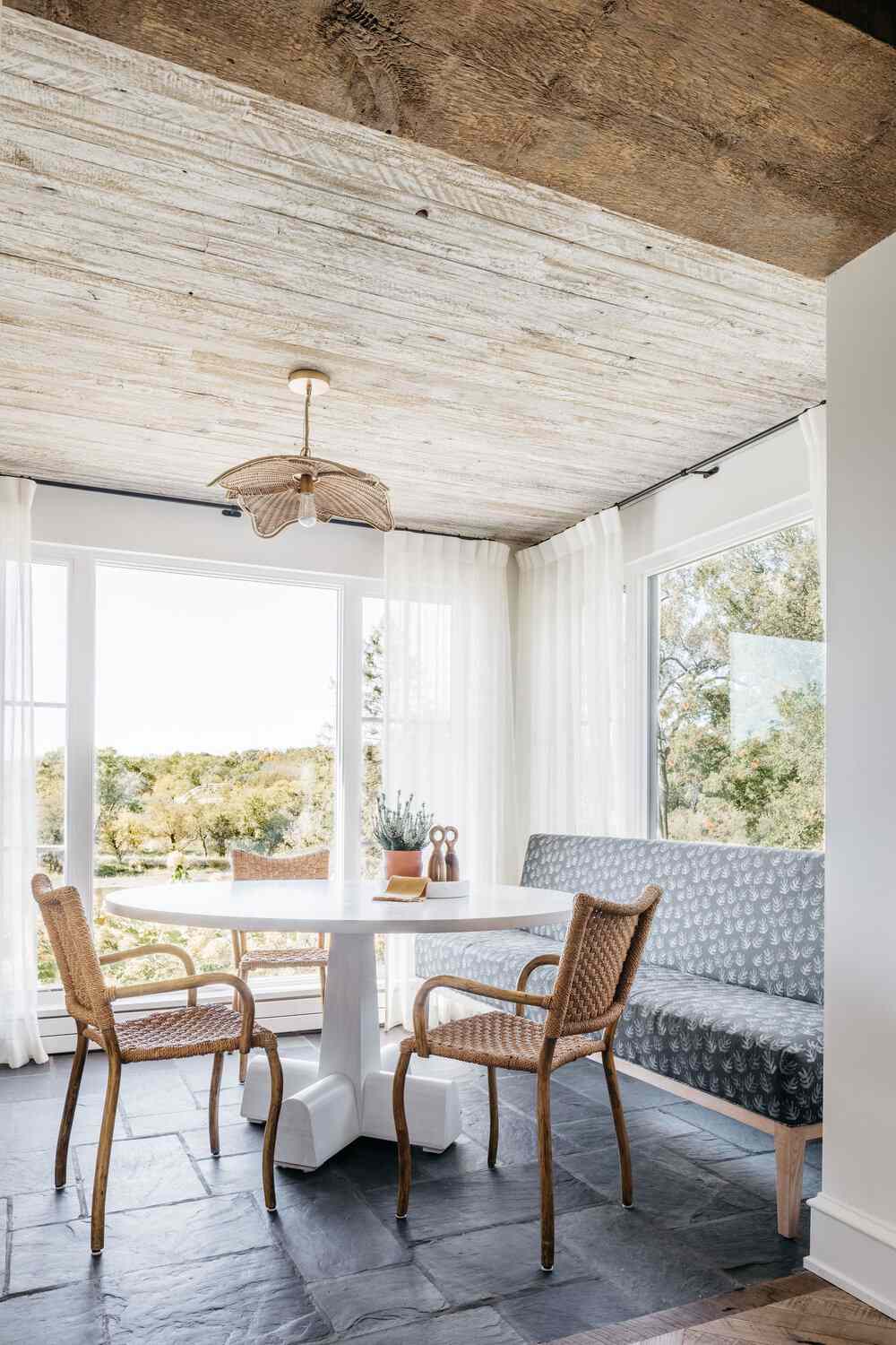 48 Small Sunroom Ideas for a Warm and Happy Space 20 Sunroom with white curtain panels and wood ceiling with a round white table, upholstered settee and wicker chairs