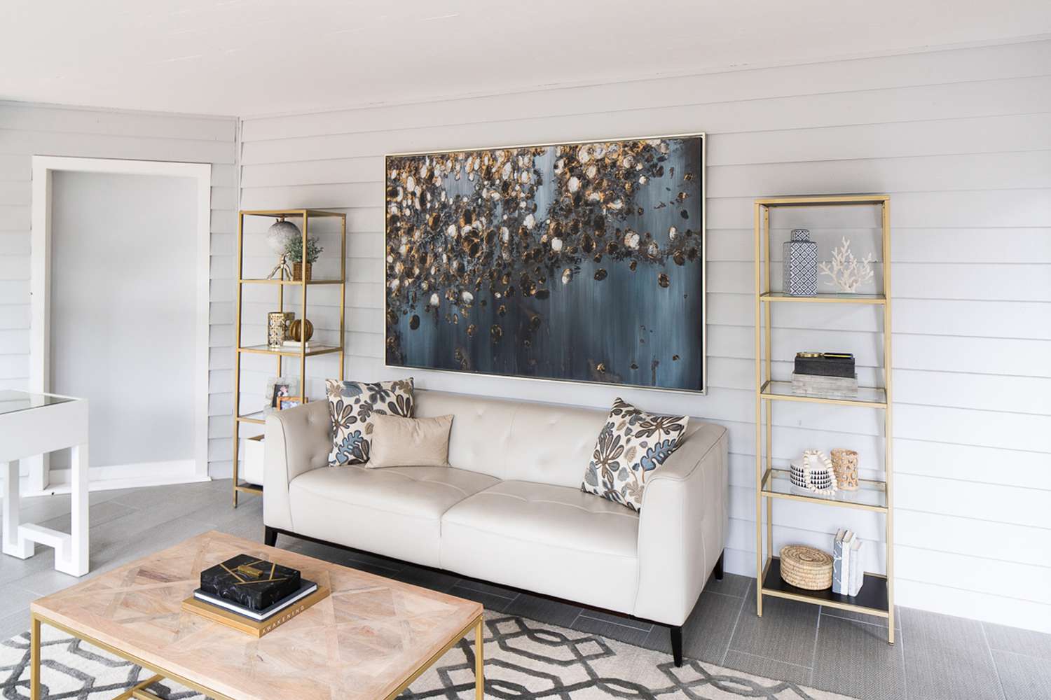 48 Small Sunroom Ideas for a Warm and Happy Space 62 Large abstract piece of art above an off-white sofa in a small sunroom