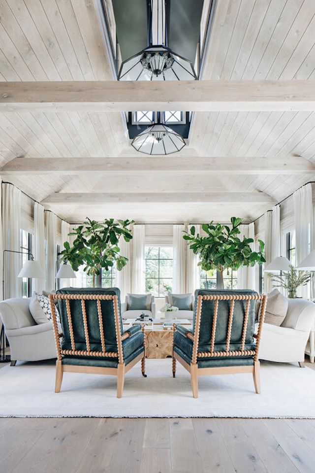 48 Small Sunroom Ideas for a Warm and Happy Space 58 Sunroom with two tall potted trees and neutral colored furniture