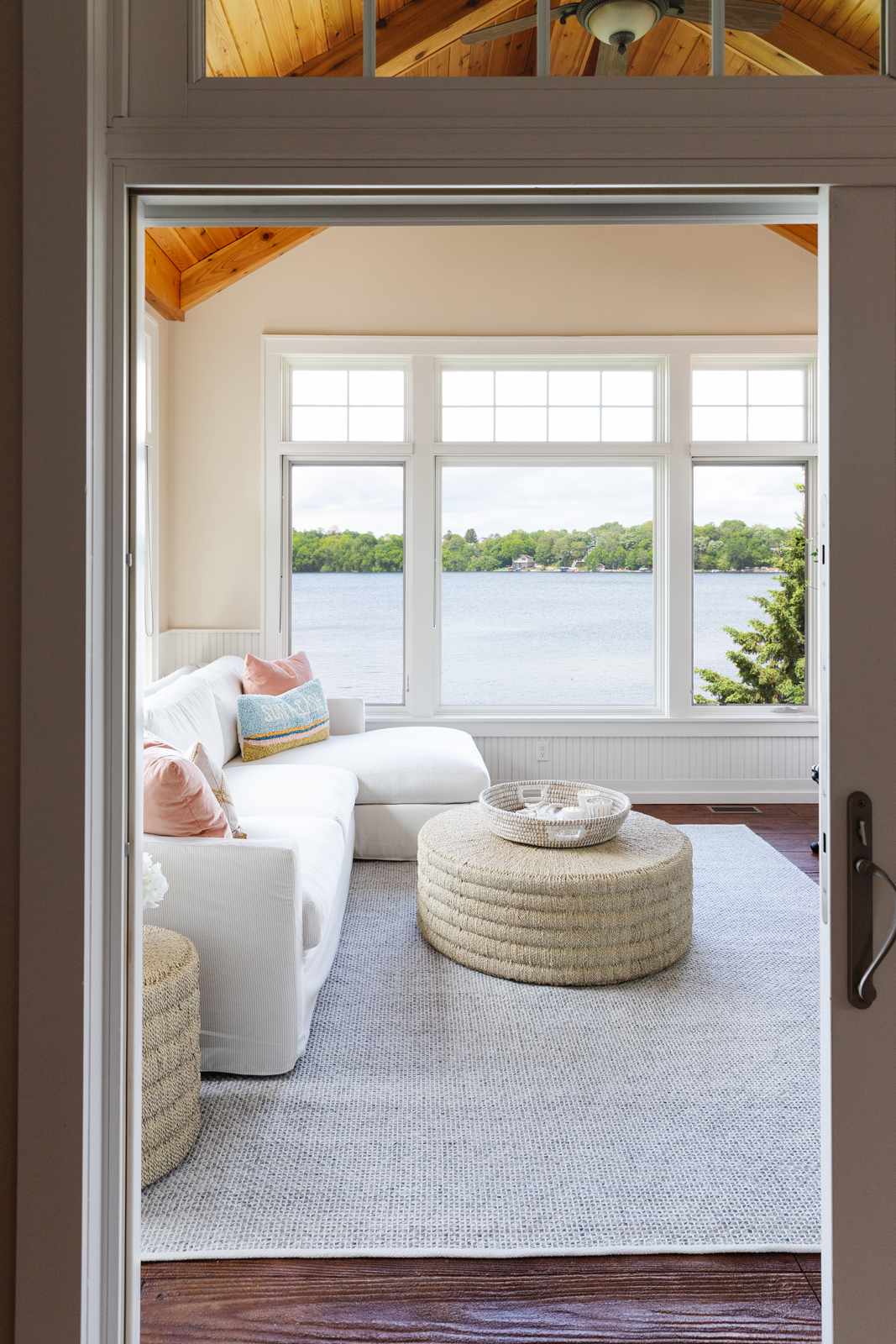 48 Small Sunroom Ideas for a Warm and Happy Space 56 Sunroom with vaulted wood ceiling, cream walls and a white sectional