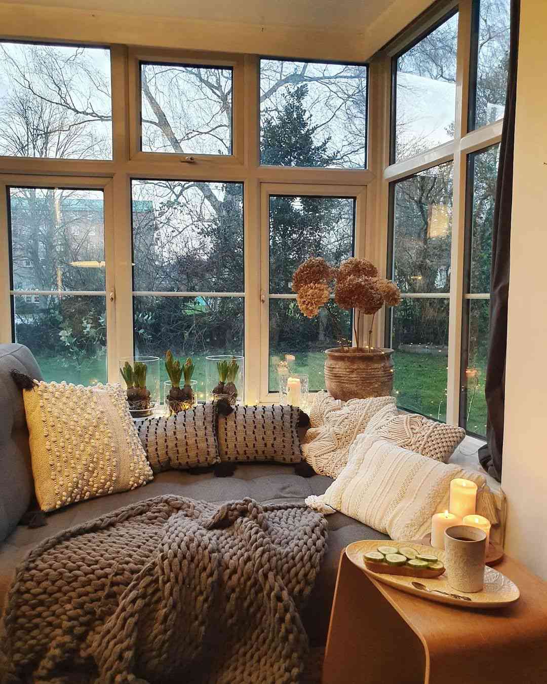 48 Small Sunroom Ideas for a Warm and Happy Space 78 Plants and candles displayed on a sunroom window sill