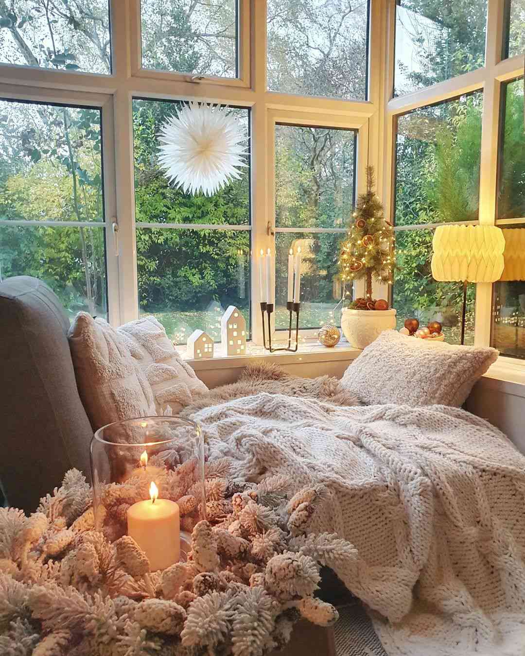 48 Small Sunroom Ideas for a Warm and Happy Space 54 Decorations and lights displayed on the window sill in a sunroom with cozy seating