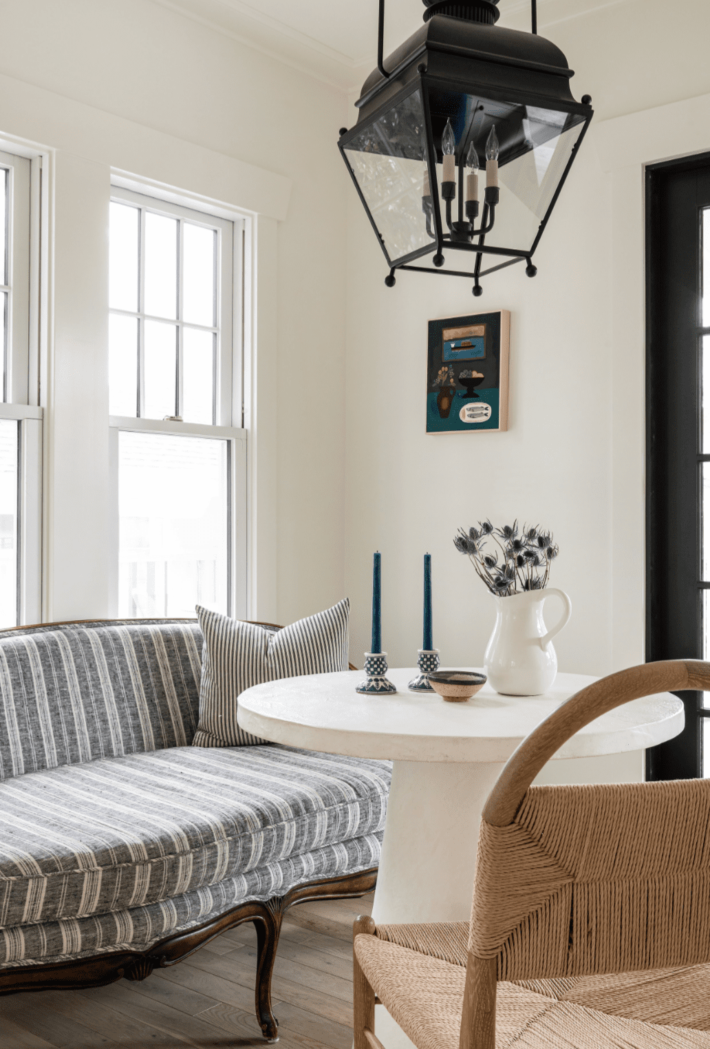 48 Small Sunroom Ideas for a Warm and Happy Space 76 Sunroom breakfast nook with a lantern pendant, upholstered settee, wood chair and modern round table