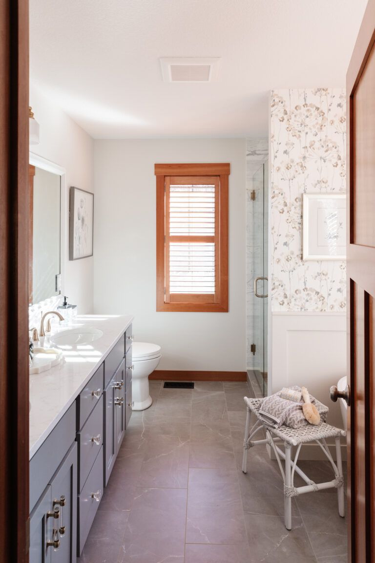 A bathroom with floral wallpaper