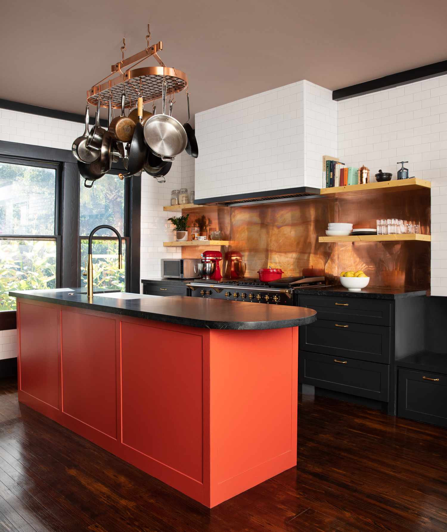 10 geniale Möglichkeiten, um einer stumpfen Küche einen Farbtupfer hinzuzufügen, teilen Designer 14 Eine dramatische Küche mit einer leuchtend orangefarbenen Insel und Kupfer -Backsplash -Panel
