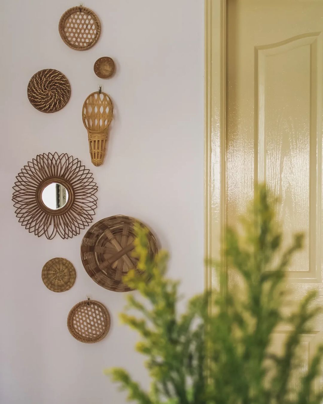 baskets and mirrors arranged on wall