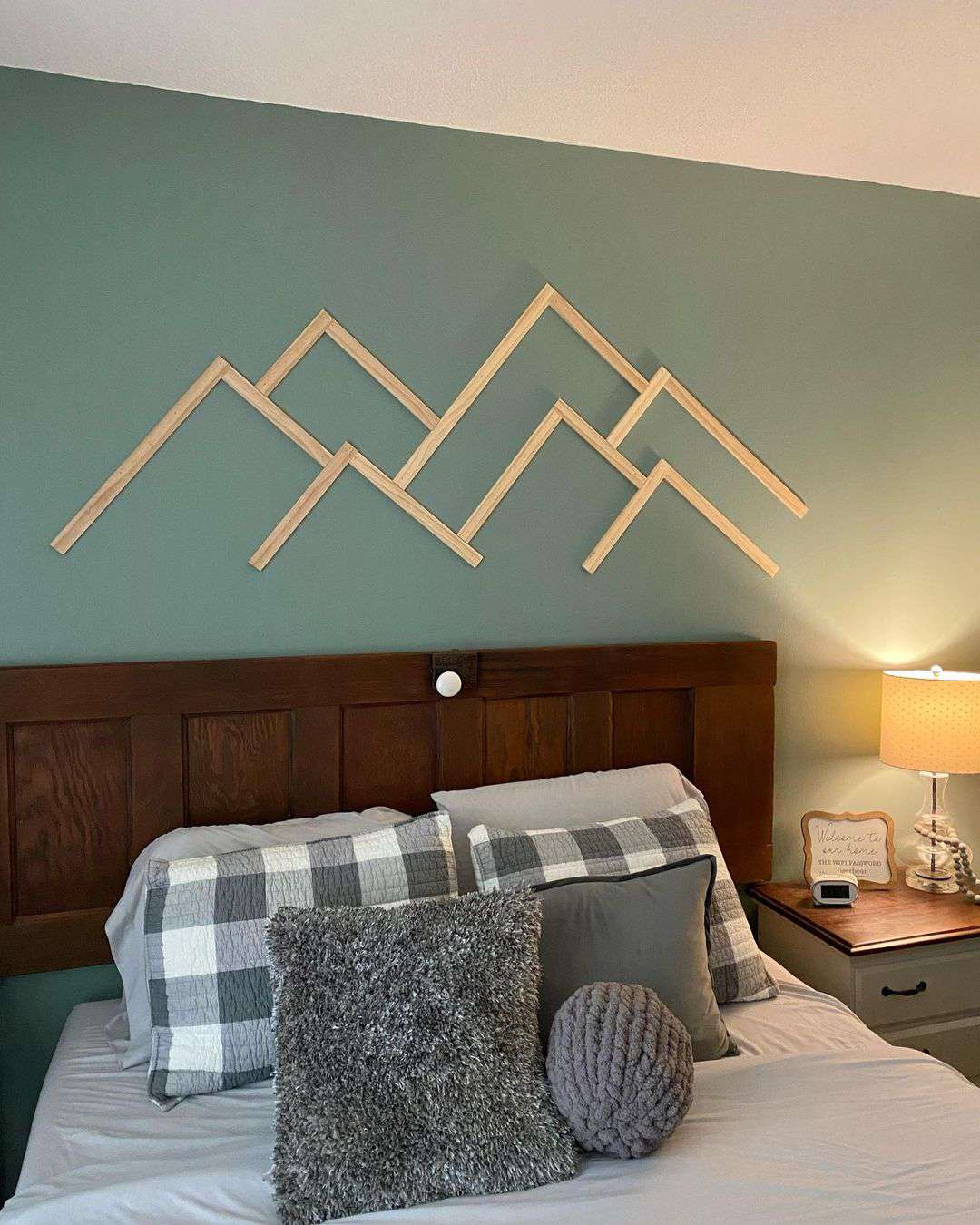 wooden mountain design over bed