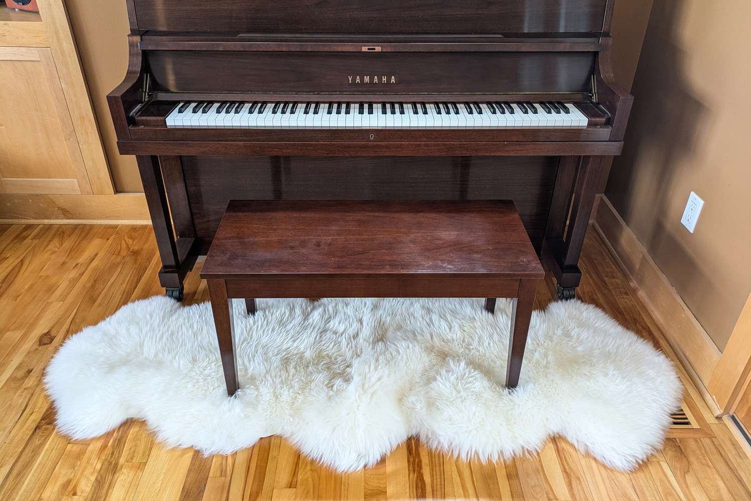 Der Schaffellenteppich unter einem Klavier