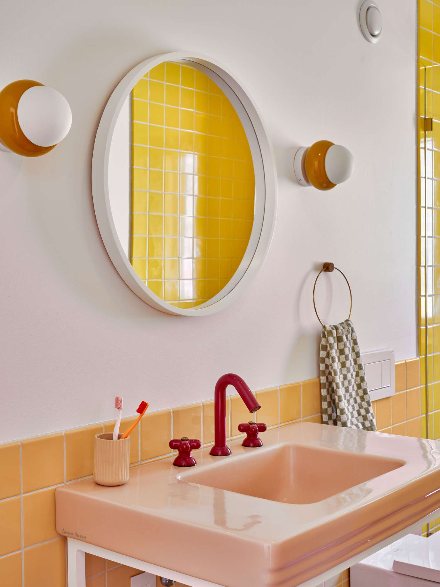 Yellow, pink, and white kids bathroom