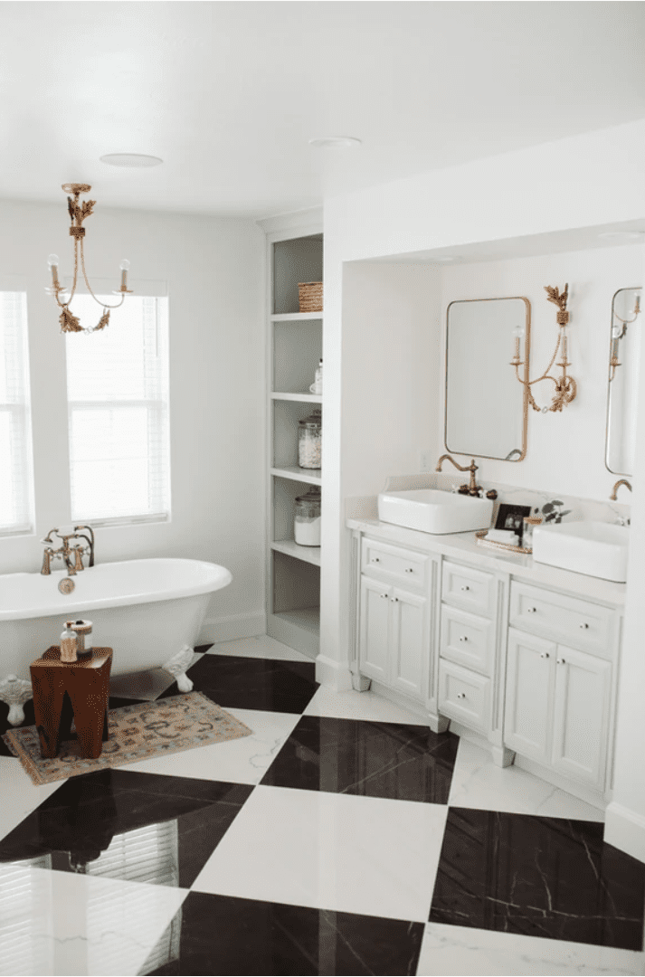 A large bathroom with vintage lighting and accents