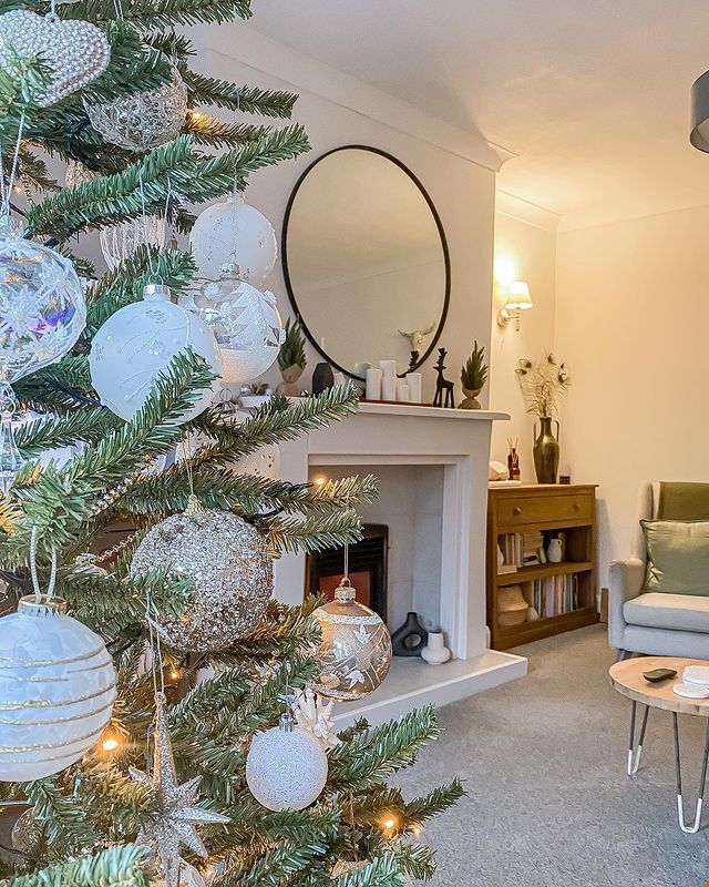 A Christmas tree with white and gold ornaments