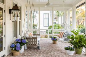Designers Have Spoken: These Front Porch Features Are Always Eyesores 6 Summery front porch with hanging chairs and bench and hydrangea flowers