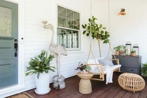 Designers Have Spoken: These Front Porch Features Are Always Eyesores 8 Front porch with light and airy siding, porch swing, and textured decor