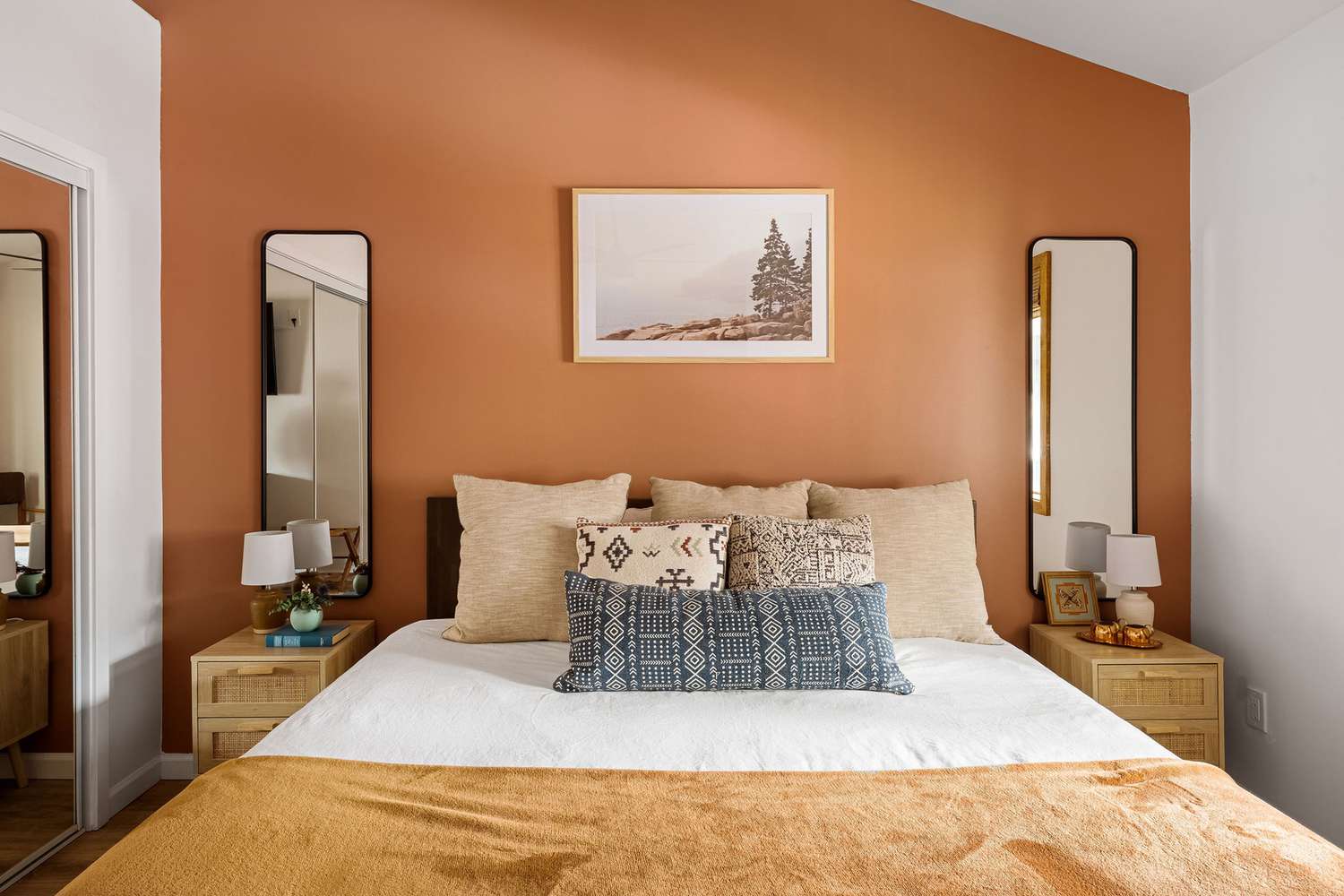 8 Designer-Approved Bedroom Decorating Tricks That Cost Less Than They Look 14 Front view of bedroom with a terracotta colored accent wall