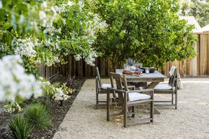 5 Tips for Designing an Outdoor Kitchen You’ll Actually Use, Straight From Designers 8 Modern farmhouse backyard with gray wood picnic dining table and chairs