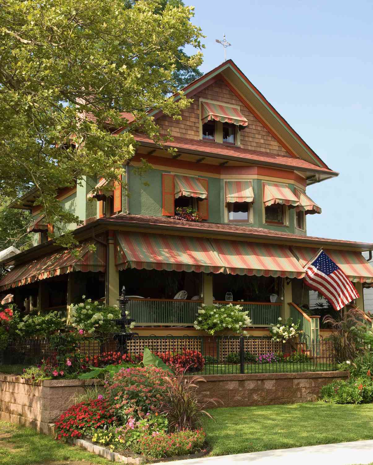 sage green house with rust accents