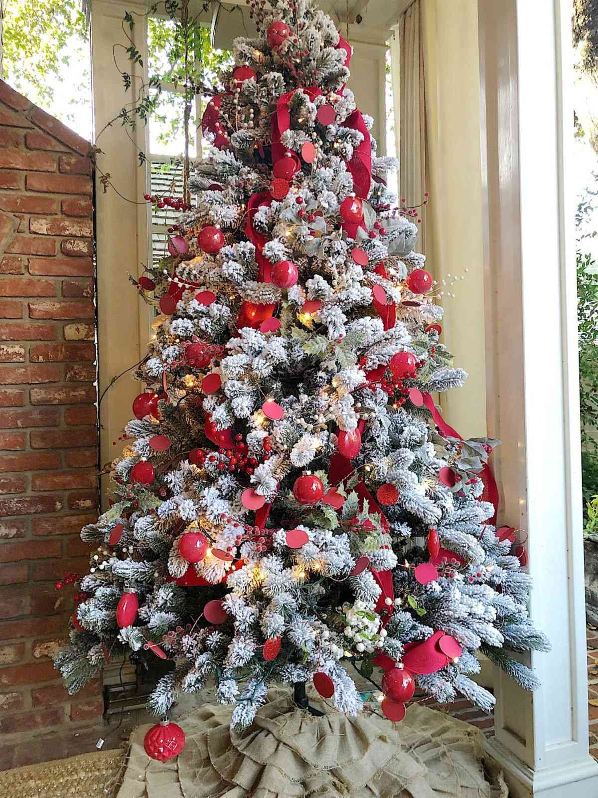 christmas tree decorated with red burlap ribbon