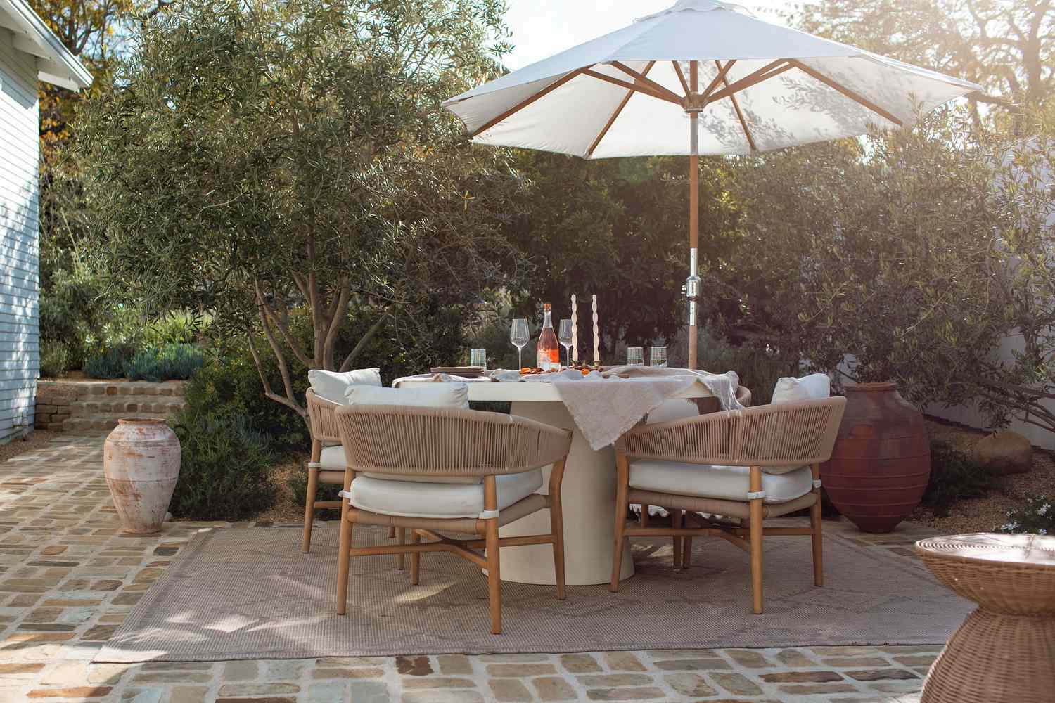 6 Backyard -Privatsphäre Korrekturen, die sich ohne den Preis luxuriös fühlen, sagen Designer, sagen Designer 16 Mediterraner Hinterhof mit Sockel eines Esstischs und natürlichen Fassstühlen