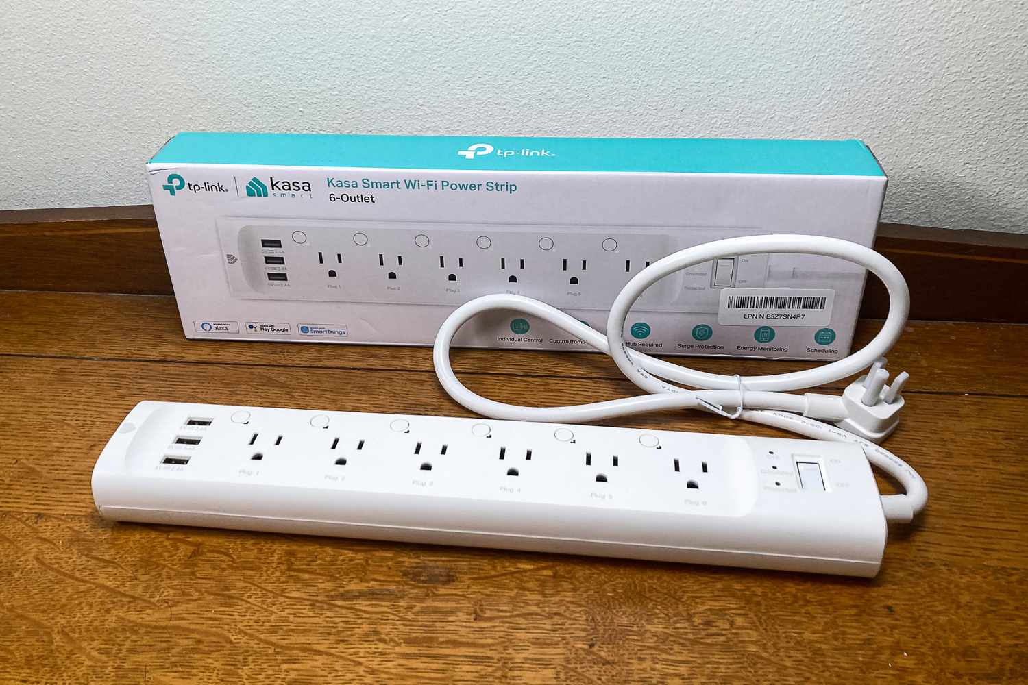 A TP-Link Kasa Smart Wi-Fi Power Strip with six outlets and three USB ports displayed with its packaging
