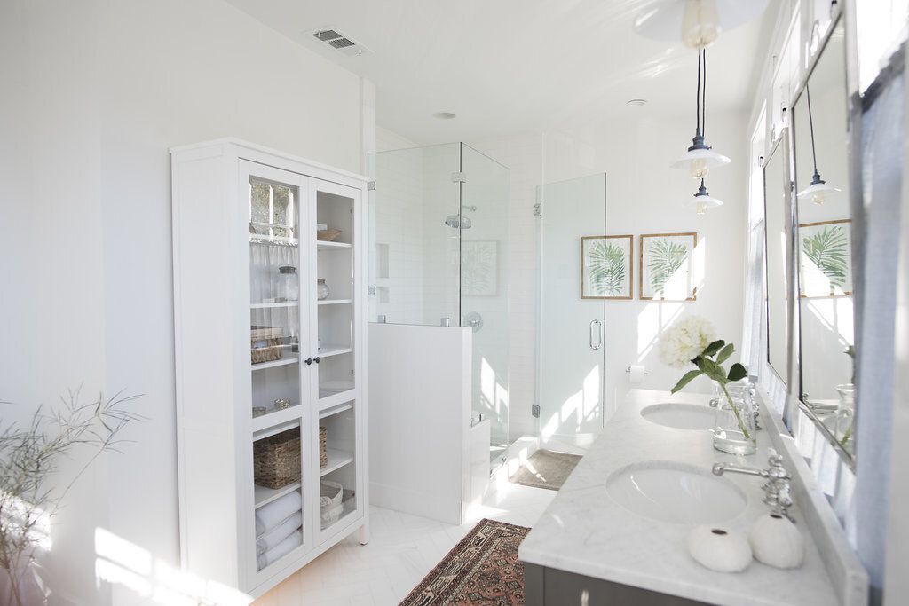 A white armoire in a large bathroom