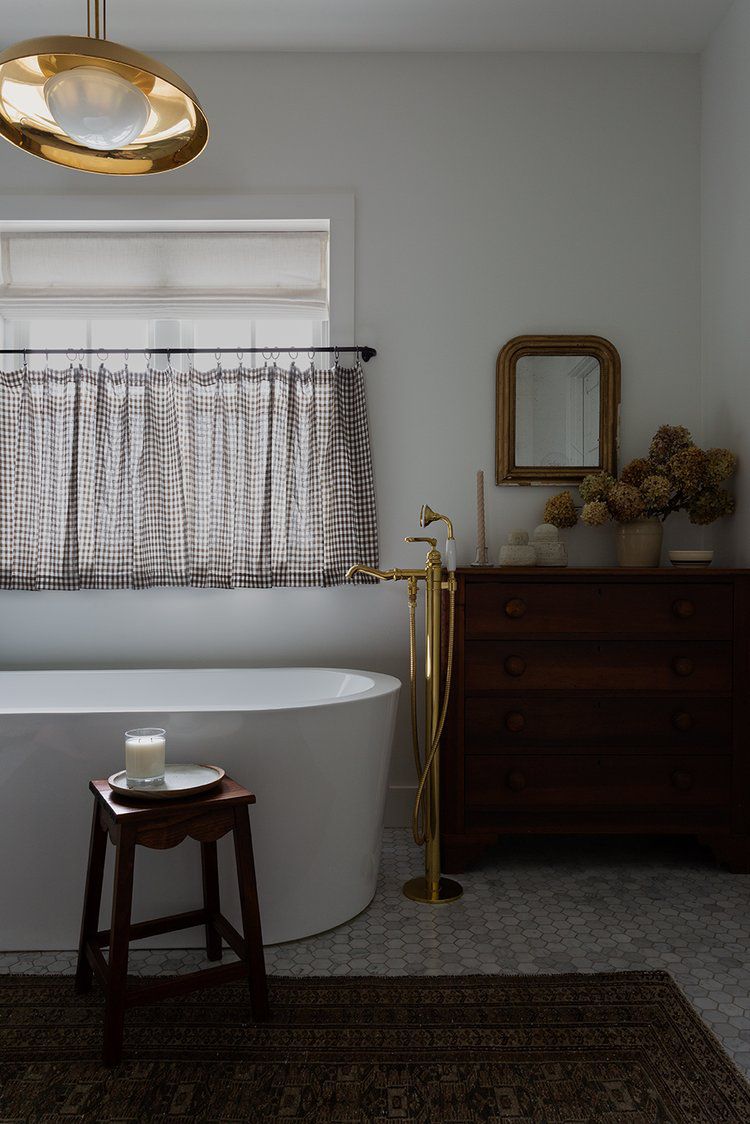 A bathroom with an antique dresser