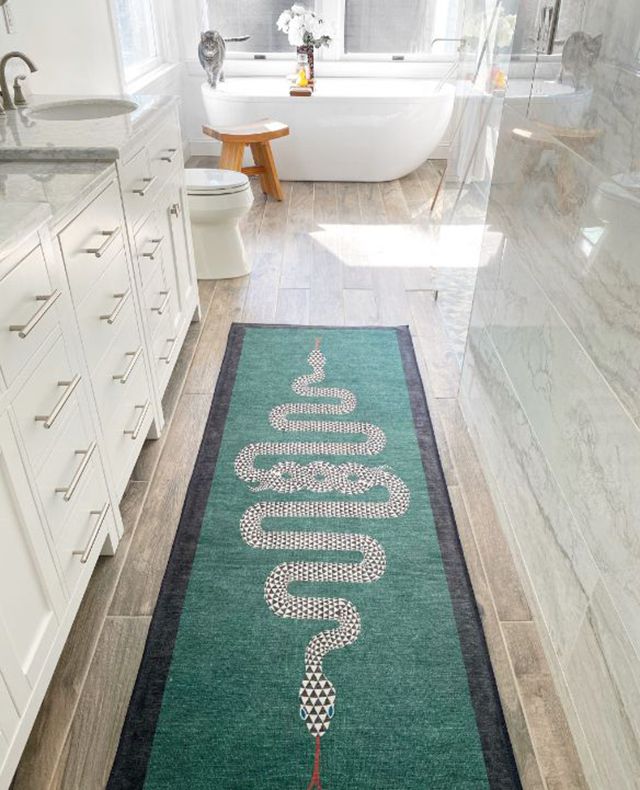 A luxurious bathroom with serpent patterned rug